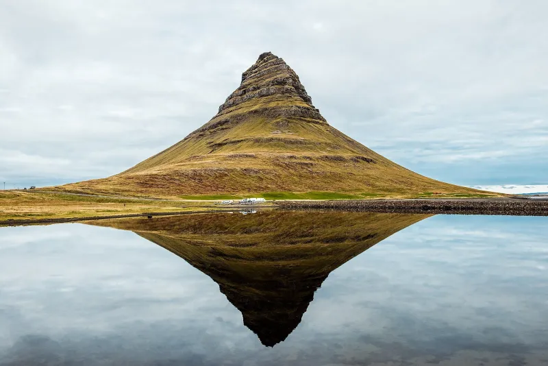 Kirkjufell mountain reflected in still water on the Snaefellsnes peninsula.