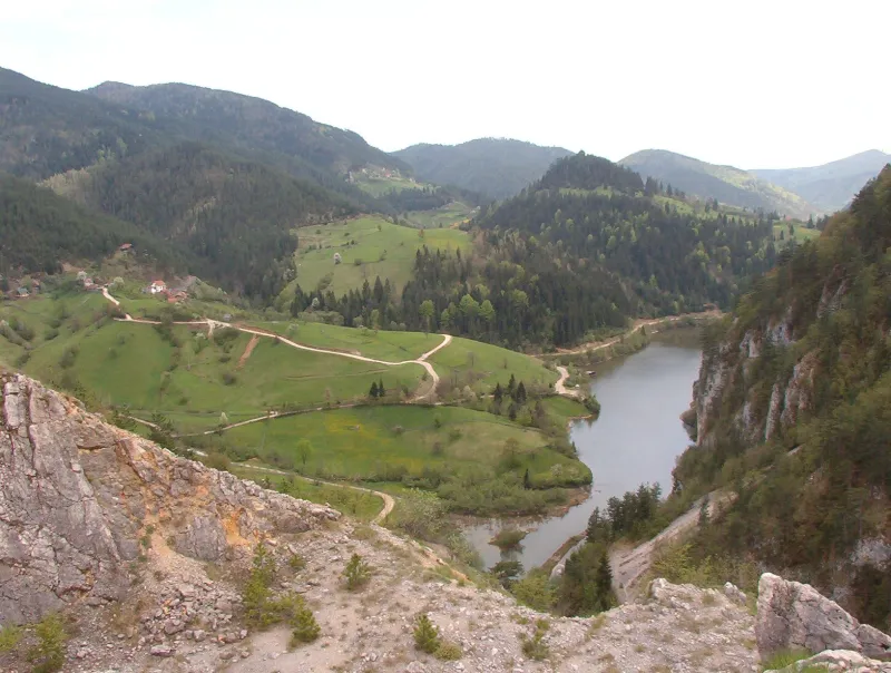 Green hills and a winding lake in the Tara mountains of western Serbia.